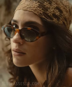 Adria Arjona wears Saint Laurent SL 567 sunglasses in the 2027 remake of The Thomas Crown Affair.