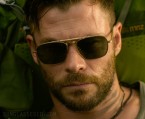Chris Hemsworth wears an unidentified pair of gold sunglasses in Extraction.