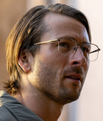 In one of his many disguises, Glen Powell wears Limited Editions Wolcott eyeglasses in the movie Hit Man.