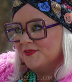 Melissa McCarthy wears purple frame eyeglasses in the 2023 movie Genie.