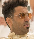 Adeel Akhtar wears Ray-Ban RB3447 Round Metal sunglasses in the 2019 Netflix film Murder Mystery.