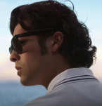 Xolo Maridueña wears black Ray-Ban RB2140 Wayfarer sunglasses in Blue Beetle (2023).