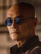 Mark Dacascos wears black round sunglasses with blue lenses in the 2023 film Knights of the Zodiac.