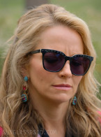 Becki Newton wears black sunglasses with crystals on the frame in Season 4 of The Lincoln Lawyer (2026).