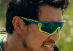 Simu Liu wears yellow and blue Oakley Jawbreaker sunglasses in the movie Arthur The King.