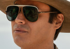 Kiowa Gordon wears dark sunglasses with a white band in the series Dark Winds.