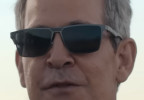 The sunglasses Tom Hollander wears in The Iris Affair (2025) have not yet been identified.