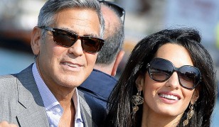 George Clooney and Amal Alamuddin during a trip on a water taxi in the canals of Venice during the wedding weekend