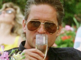 Gordon Gekko (Michael Douglas) wearing the Cartier Vendome Santos sunglasses in Wall Street.