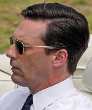 Jon Hamm, in a red convertible, wearing the RE Aviators during the filming of an