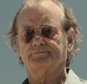 Bill Murray wears Ray-Ban 3025 Large Aviator polarized sunglasses with gold frame and pink lenses in Rock the Kasbah.