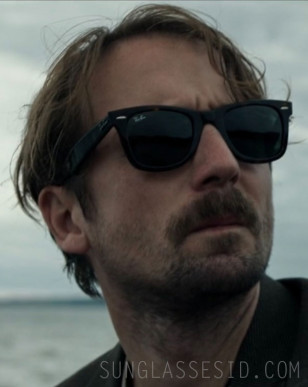 Tom Basden wears a pair of Ray-Ban 2140 Wayfarer sunglasses in the movie The Ballad of Wallis Island.