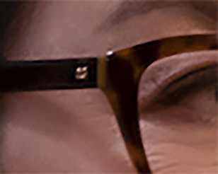 The eyeglasses have a small gold DG logo on the temples.