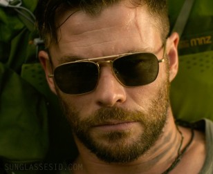 Chris Hemsworth wears an unidentified pair of gold sunglasses in Extraction.