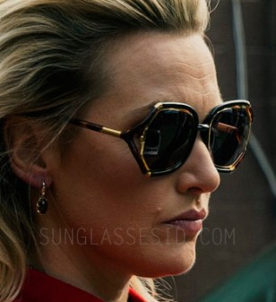 In the movie Triple 9, actress Kate Winslet wears a pair of tortoise and gold sunglasses with oversized, open temple frame design.
