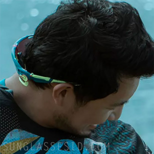 Simu Liu wears yellow and blue Oakley Jawbreaker sunglasses in the movie Arthur The King.
