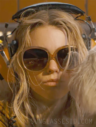 Milly Alcock wears oversized sunglasses in the movie Supergirl.