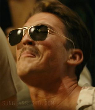 In this shot, the Ray-Ban logo can be just spotted on Miles Teller's Ray-Ban RB3136 Caravan sunglasses in the movie Top Gun: Maverick.