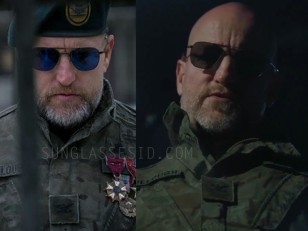 In War for the Planet of the Apes, Woody Harrelson wears black RE Aviator sunglasses which in the outdoor light seem to have blue lenses.