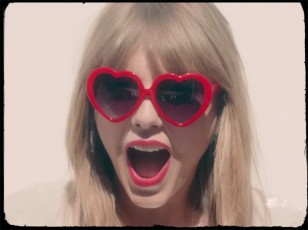 Taylor Swift wears red heart-shaped sunglasses in the 22 music video.