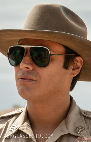 Kiowa Gordon wears dark sunglasses with a white band in the series Dark Winds.