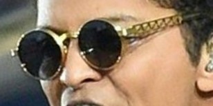 Bruno Mars wearing vintage gold Jean-Paul Gaultier sunglasses during Super Bowl 50