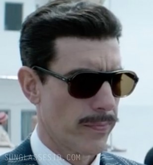 Sacha Baron Cohen wears 1970s style large aviator sunglasses in the Netflix series The Spy.