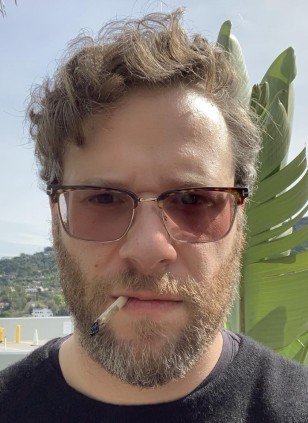 Seth Rogen wearing Tom Ford Half-Rim Optical FT5504 eyeglasses with transitional lenses.