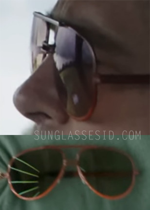 The sunglassses worn by Brad Pitt have a vintage aviator shape, brown frame, straight brow bar and a double-bar nose bridge, possibly gold.